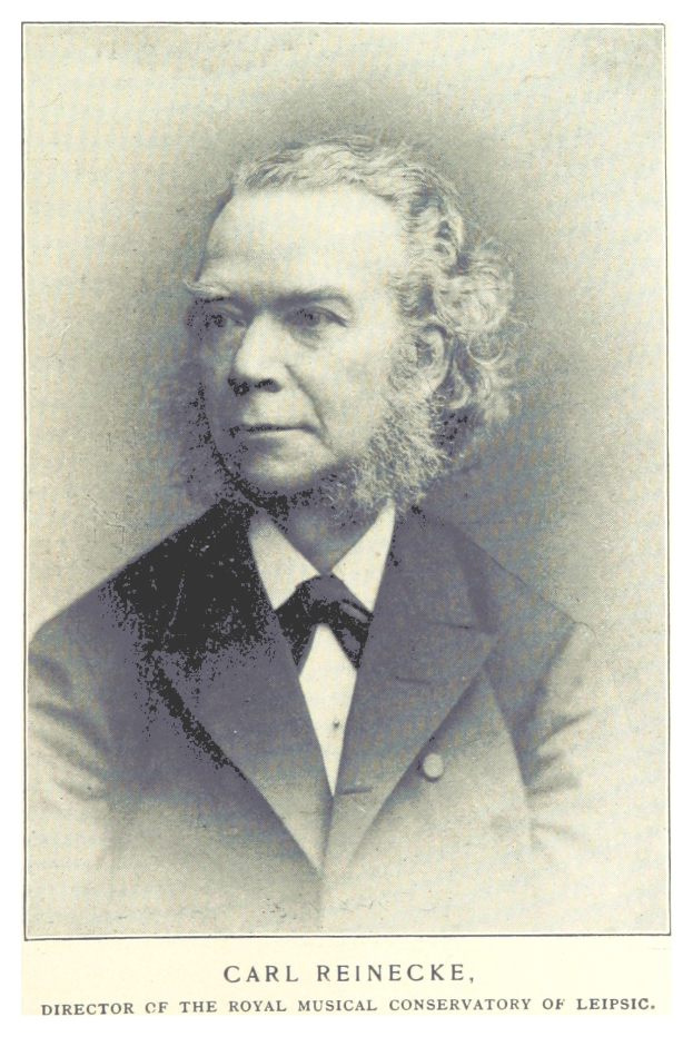 Schwarzes und weißes Foto von Carl Reinecke, Direktor des Königlichen Musikalischen Konservatoriums von Leipzig, der einen Anzug trägt, mit Text unten.