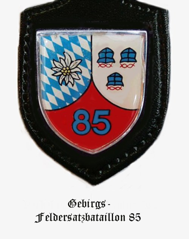 A circular badge with the number 85 and German text at the bottom, representing the Bavarian football team.